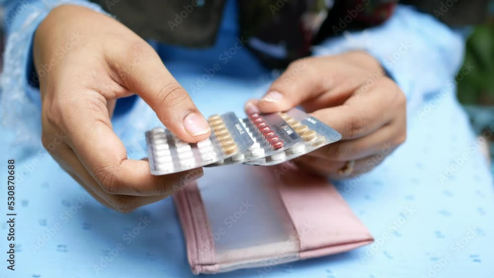 women hand holding birth control pills close up women hand holding birth control pills close up
