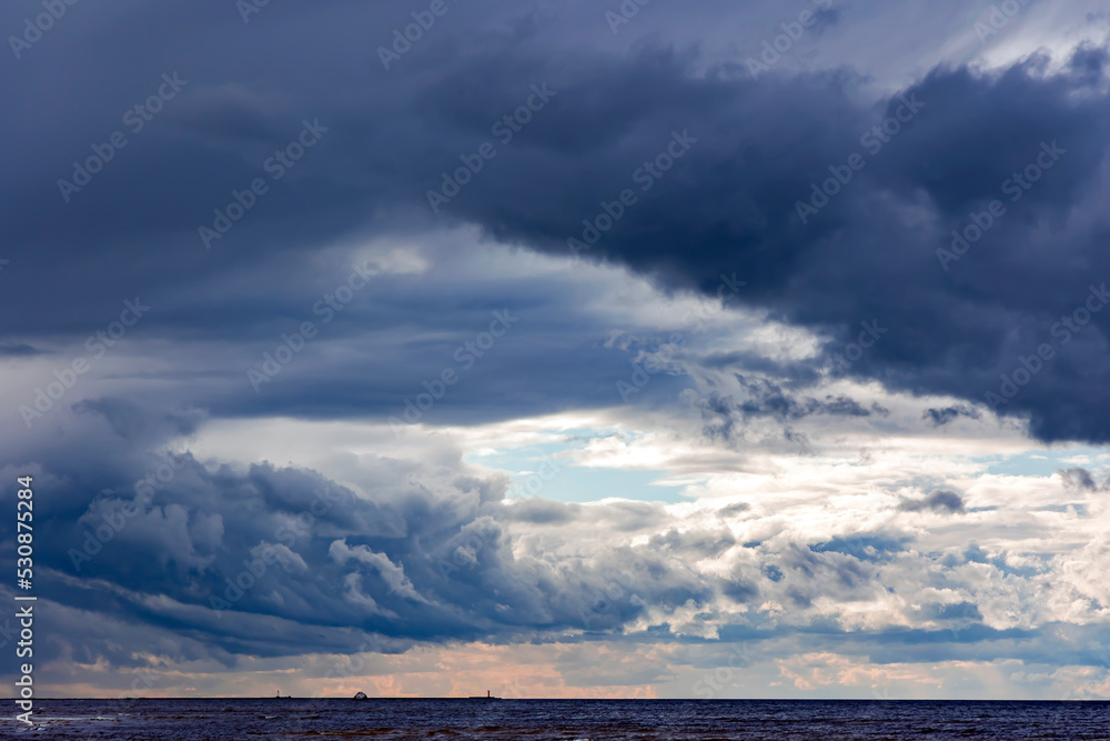 Dramatic stormy dark cloudy sky over Baltic sea just before a sea storm in Riga, Latvia. Nature environment concept.	