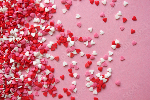 Multicolored background with candy hearts. Pink, white, red hearts. Love. Simovl loves. Valentine Day. Lots of little hearts. Copy space for text.