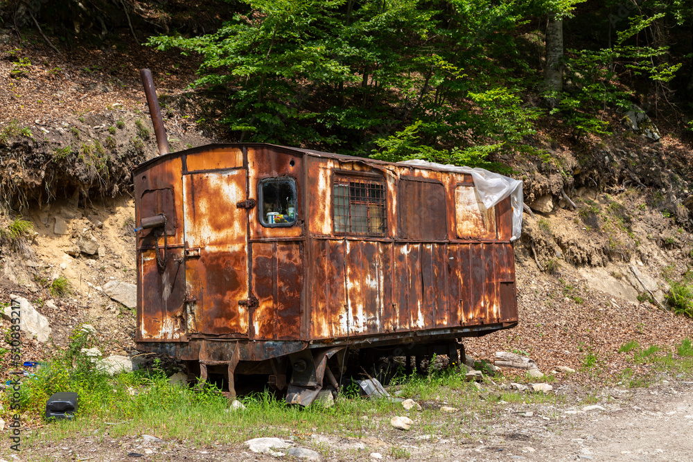Old and rusty wagon in the Gilort Valley, Novaci, Romania. It serves as a shelter for forest workers. Old and rusty wagon in the Gilort Valley, Novaci, Romania. It serves as a shelter for forest workers.