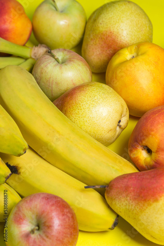 Various fruits on a yellow background. Fruit as a background for your image