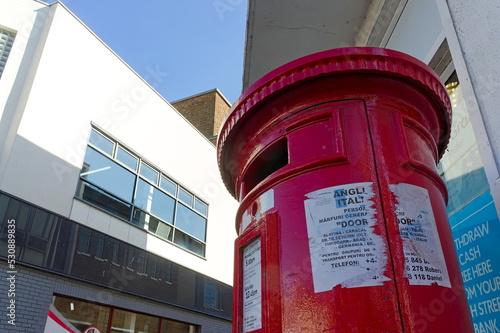 Canvas Print looking up at a red British postbox on the street