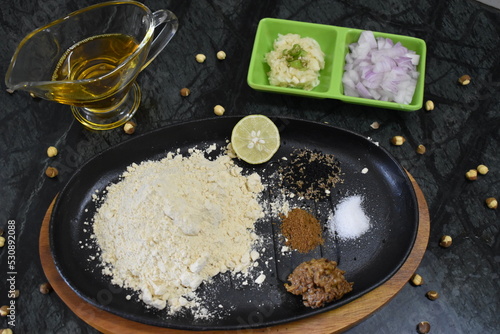 Ingredient of sattu paratha or litti stuffing of Bihar. Include sattu powder, salt, lemon, onion, garlic, pickle, mustard oil, onion seed.  photo