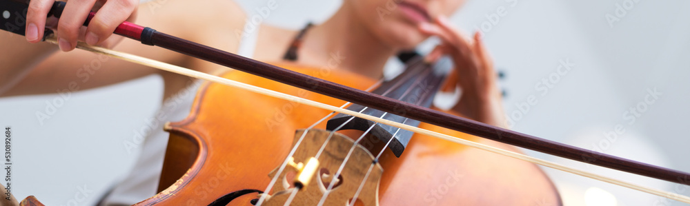 Young woman playing cello on the concert at night Young woman playing cello on the concert at night