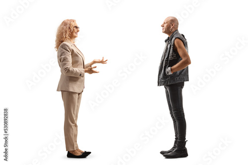Woman talking to a bald punk man