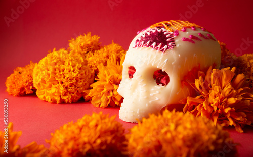 Sugar skulls with Candle, Cempasuchil flowers or Marigold and Papel Picado. Decoration traditionally used in altars for the celebration of the day of the dead in Mexico photo