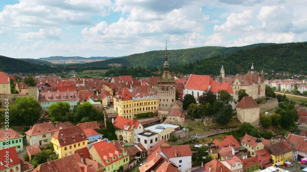 Aerial drone timelapse view of the Historic Centre of Sighisoara, Romania. Old buildings, narrow streets with people, Sighisoara Clock Tower Aerial drone timelapse view of the Historic Centre of Sighisoara, Romania. Old buildings, narrow streets with people, Sighisoara Clock Tower