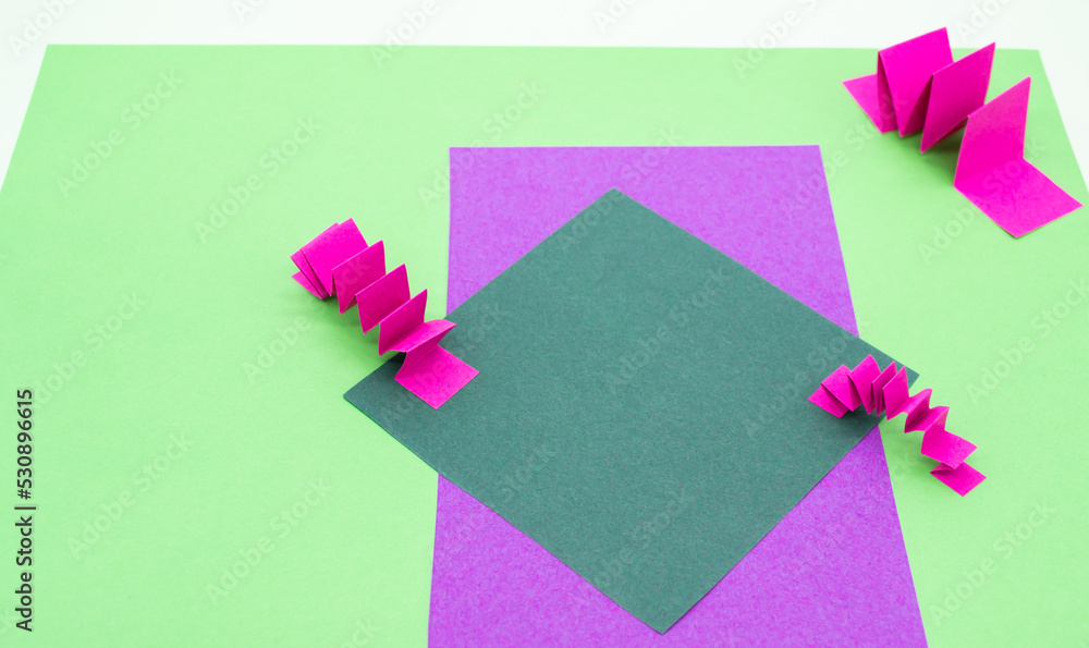 Abstract background in green, pink and purple colors with 3D paper elements, zig zag pattern . As a backdrop for advertising products, copy space Abstract background in green, pink and purple colors with 3D paper elements, zig zag pattern . As a backdrop for advertising products, copy space