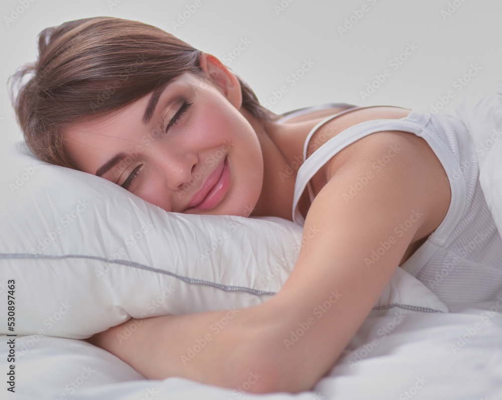 Beautiful girl sleeps in the bedroom, lying on bed Beautiful girl sleeps in the bedroom, lying on bed