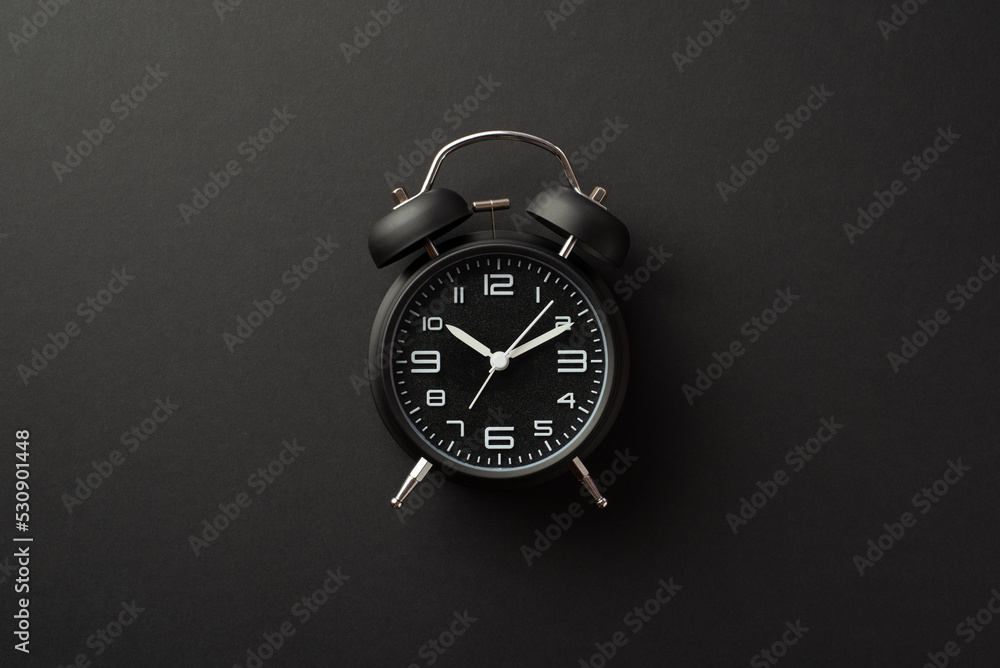 Black friday concept. Top view photo of black alarm clock on isolated black background - obrazy, fototapety, plakaty 