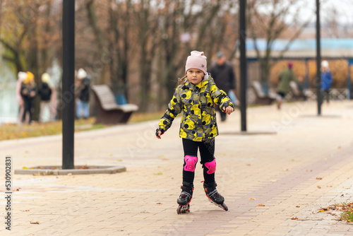 Cute little girl learning to roller skate