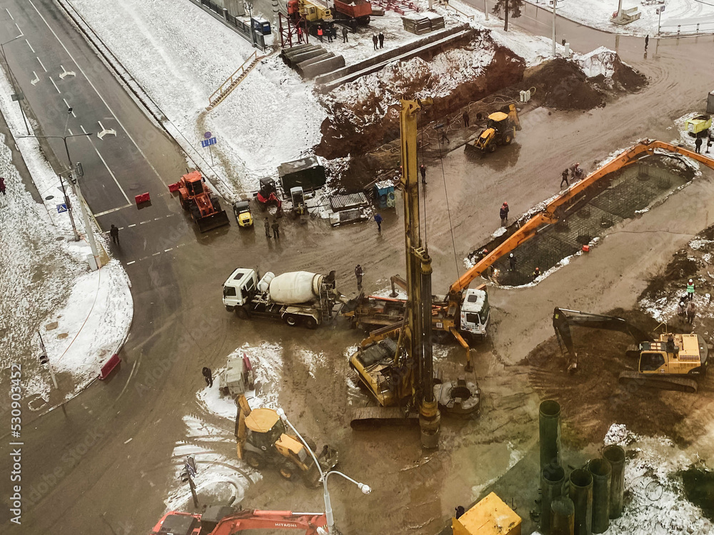 construction of a bridge in the city center. construction equipment, machines for mixing concrete and making asphalt. construction of large concrete structures construction of a bridge in the city center. construction equipment, machines for mixing concrete and making asphalt. construction of large concrete structures