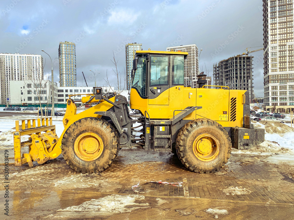 construction equipment on site. building houses and laying roads. bright, yellow excavator for digging holes and laying plumbing communications construction equipment on site. building houses and laying roads. bright, yellow excavator for digging holes and laying plumbing communications