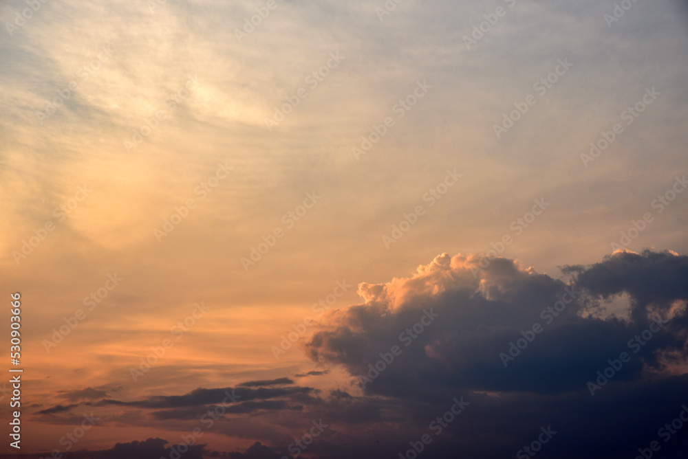 Beautiful sunset summer sky clouds and a flying plane. Sunset evening sky in the evening.