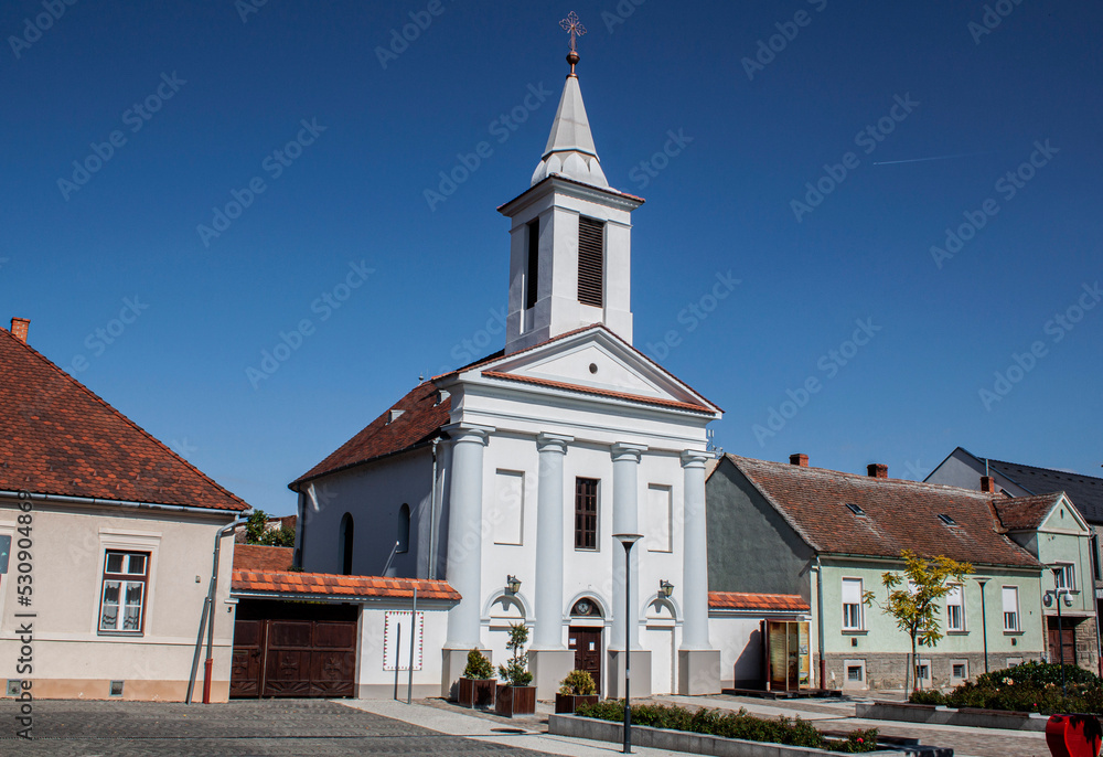 Obraz premium Historical Evangelical Church in the old town of Sárvár, Hungary, Europe. With its white-painted walls and harmonious proportions, it's an example of the Classicist church architecture of Transdanubia