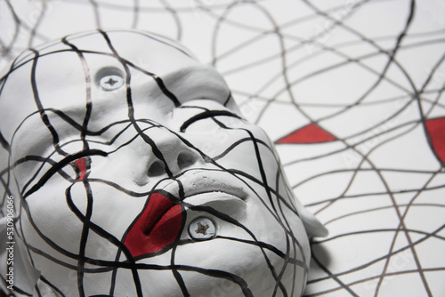 Female face portrait. Sculpture of white face with closed eyes. Abstract geometric pattern  inspired by the painter Mondrian.