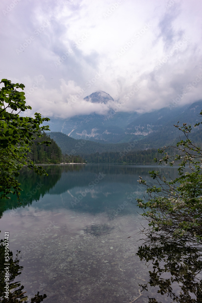 Trentino. lake of Tovel. Mountains, trees and clouds.
