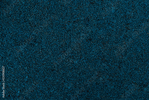 Dark blue texture of rubber crumb.Rubber asphalt. Copy space. A great background for your design.