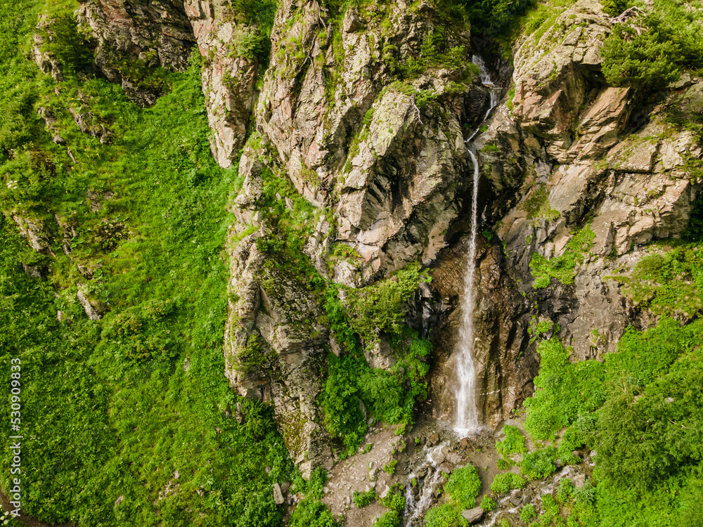 Aerial view of waterfall in rocky mountain, wide shot