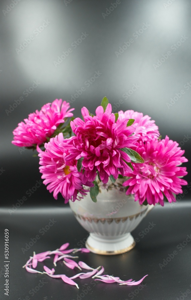 Obraz premium Romantic, holiday, fashion concept. Bouquet of flowers in lilac, pink tones against a black wall.Background, copy space, postcard