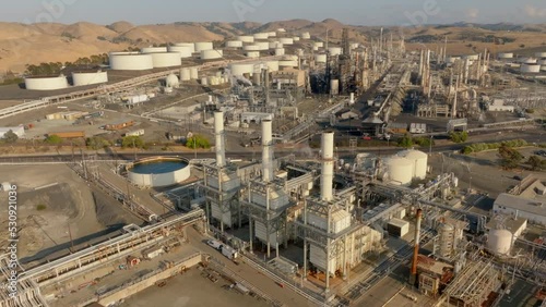 Oil Refinery Three Smoke Stacks with Plant in Background - Orbit Left to Right