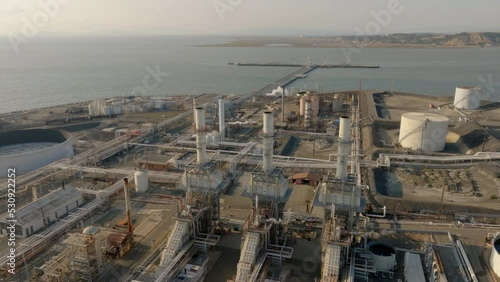 Oil Refinery Three Smoke Stacks with Ocean - Orbit Left to Right