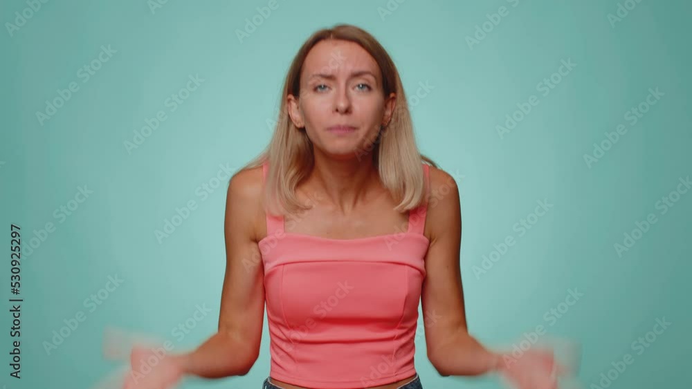 How could you. Sincere irritated woman raising hands in indignant expression asking reason of failure demonstrating disbelief irritation by troubles. Young confused girl isolated on blue background How could you. Sincere irritated woman raising hands in indignant expression asking reason of failure demonstrating disbelief irritation by troubles. Young confused girl isolated on blue background