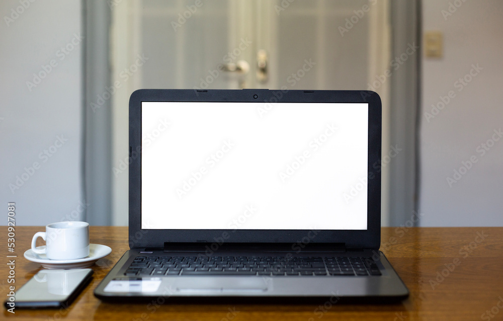 Close up view computer mockup white background on table. Cell phone blank screen. Laptop with blank screen at work desk. Close up view computer mockup white background on table. Cell phone blank screen. Laptop with blank screen at work desk.