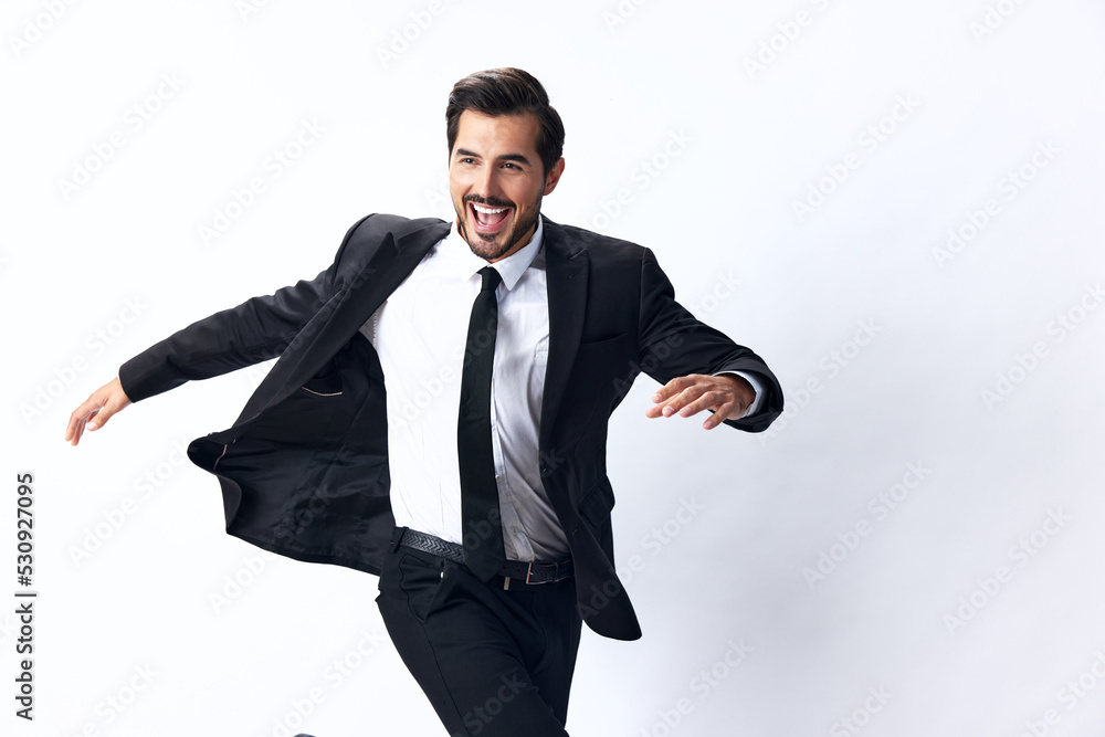 A business man jumps in a business suit and smiles with his teeth on a white isolated background running. The concept of a happy businessman A business man jumps in a business suit and smiles with his teeth on a white isolated background running. The concept of a happy businessman