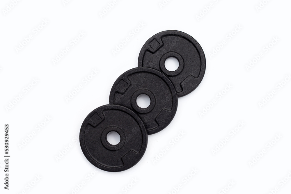 Black weight plates on white background. Gym equipment Black weight plates on white background. Gym equipment