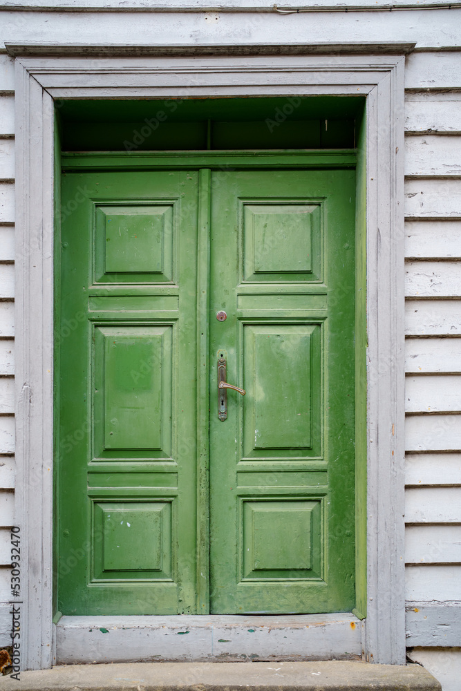 Old green house door in Norway