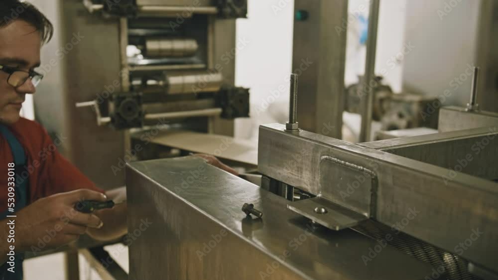 Young Worker Sets Up A Mechanism Mechanic Factory Knot And Chain Setup Young Worker Sets Up A Mechanism Mechanic Factory Knot And Chain Setup
