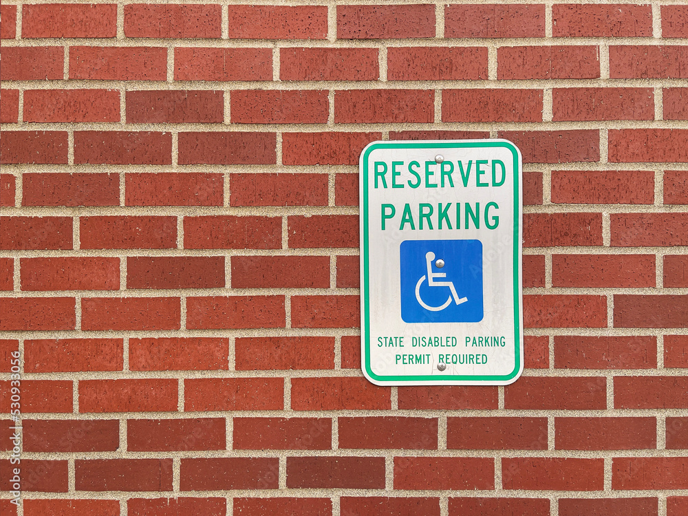 Obraz premium Reserved Parking or Handicapped Parking sign on the red brick wall