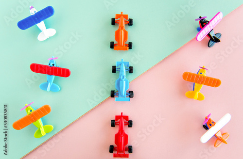 children's day, plastic toys on pink and green background.