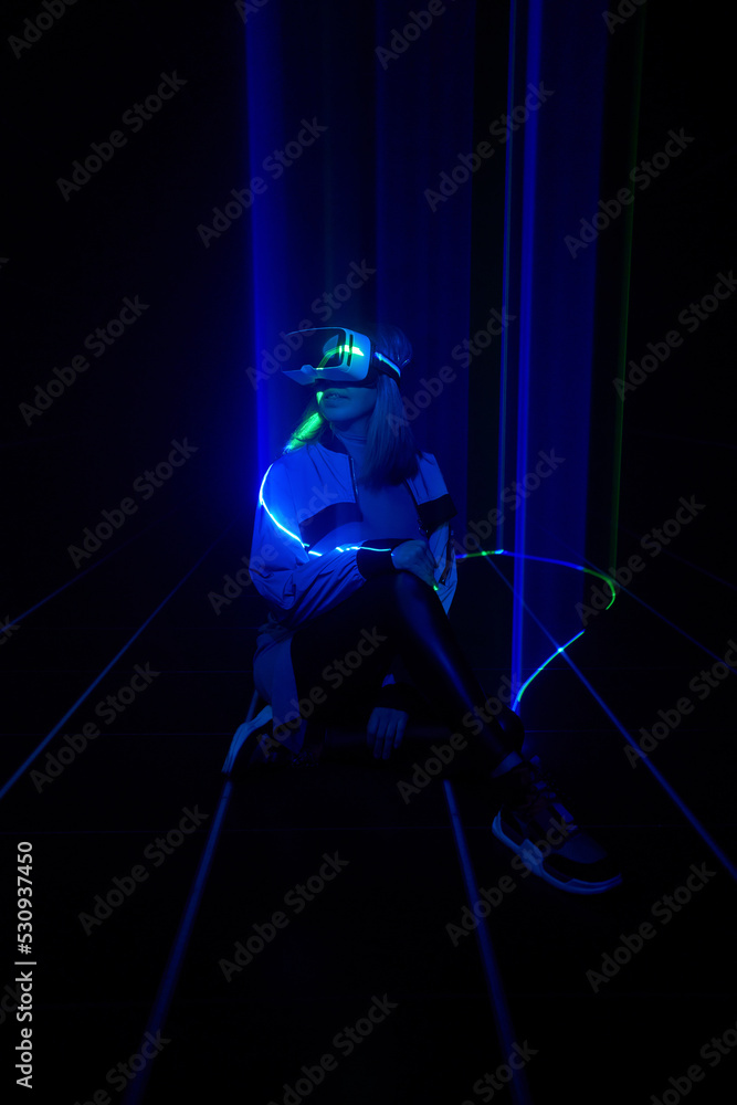 Naklejka premium Woman is using virtual reality headset to access in metaverse.