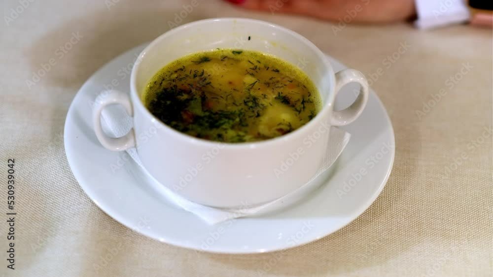 Unrecognizable woman eating hot soup, sitting at table in restaurant. Unrecognizable woman eating hot soup, sitting at table in restaurant.