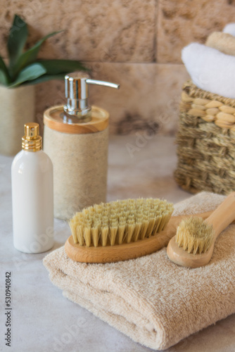 Brushes for dry lymphatic drainage massage on a light towel. Spa accessories.