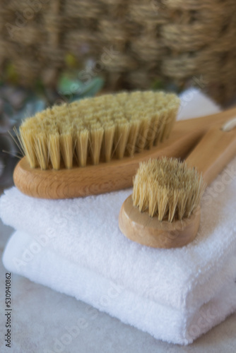 Brushes for dry lymphatic drainage massage on a white towel
