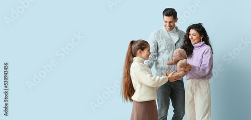 Happy parents giving toy to...