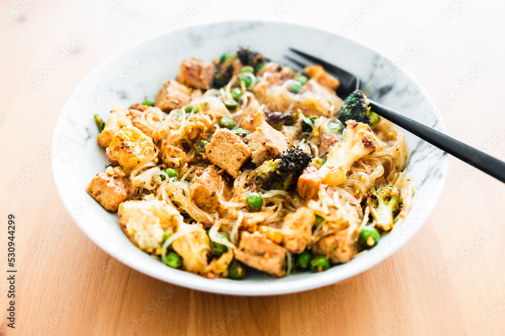 healthy plant-based food, vegan noodles stir fry with broccoli peas and marinated tofu chunks healthy plant-based food, vegan noodles stir fry with broccoli peas and marinated tofu chunks