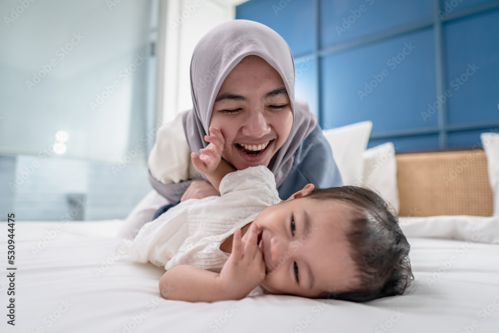 Young Asian Mother Playing and Laughing with Daughter Young Asian Mother Playing and Laughing with Daughter