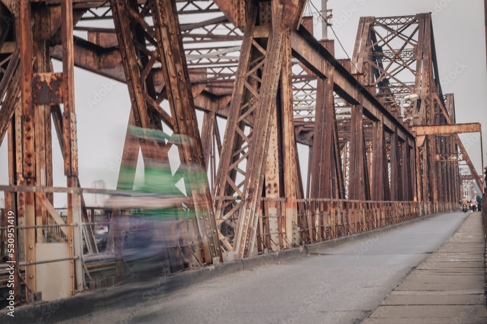 Speed blurred motorbikes on Long Bien Bridge in Hanoi Speed blurred motorbikes on Long Bien Bridge in Hanoi