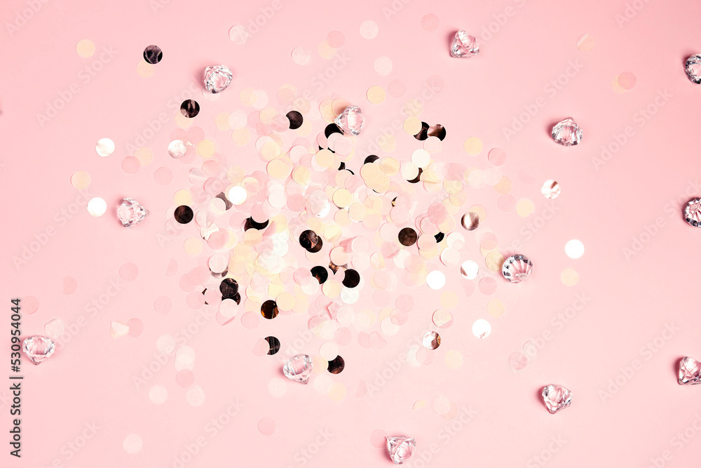 Colorful festive round confetti dots and crystals on pink background. Holiday greeting card.
