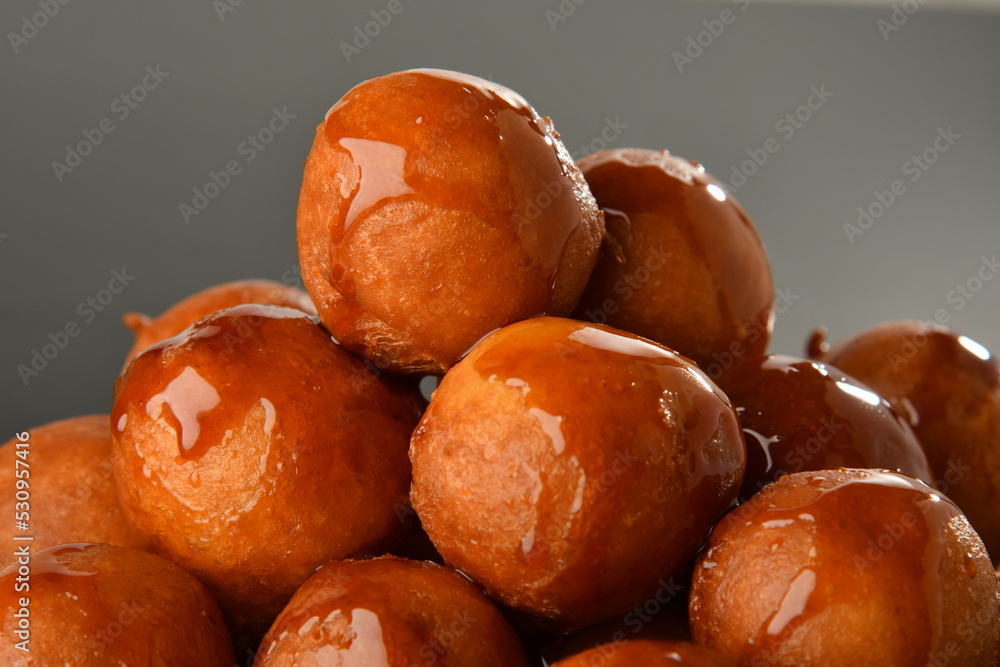luqaimat or lokma. Freshly fried Lokma (luqma - arabic) piled high a popular middle eastern dessert of small dough balls deep fried then coated in sugar or honey syrup
luqaimat or lokma. Freshly fried Lokma (luqma - arabic) piled high a popular middle eastern dessert of small dough balls deep fried then coated in sugar or honey syrup
