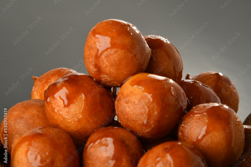 luqaimat or lokma. Freshly fried Lokma (luqma - arabic) piled high a popular middle eastern dessert of small dough balls deep fried then coated in sugar or honey syrup
luqaimat or lokma. Freshly fried Lokma (luqma - arabic) piled high a popular middle eastern dessert of small dough balls deep fried then coated in sugar or honey syrup
