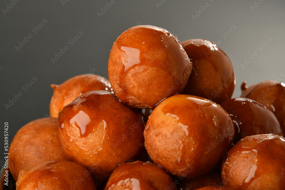 luqaimat or lokma. Freshly fried Lokma (luqma - arabic) piled high a popular middle eastern dessert of small dough balls deep fried then coated in sugar or honey syrup
luqaimat or lokma. Freshly fried Lokma (luqma - arabic) piled high a popular middle eastern dessert of small dough balls deep fried then coated in sugar or honey syrup