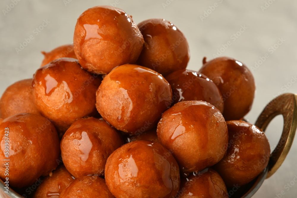 luqaimat or lokma. Freshly fried Lokma (luqma - arabic) piled high a popular middle eastern dessert of small dough balls deep fried then coated in sugar or honey syrup
luqaimat or lokma. Freshly fried Lokma (luqma - arabic) piled high a popular middle eastern dessert of small dough balls deep fried then coated in sugar or honey syrup