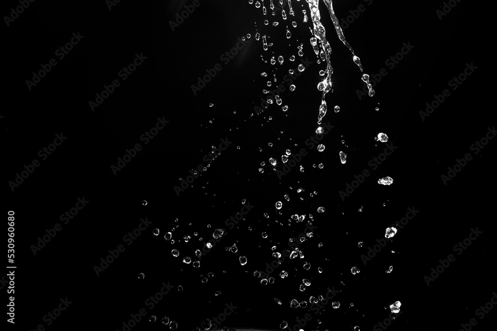 water splashes isolated on black background. white jets with drops
