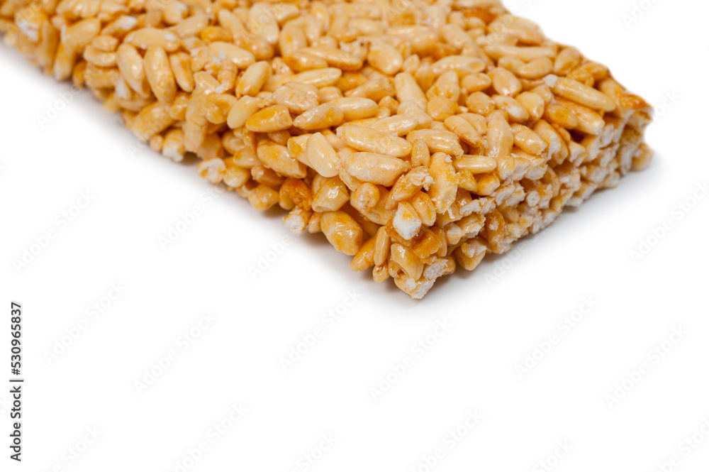 Sweetness from grains of puffed rice, shot close-up on a white background. Sweetness from grains of puffed rice, shot close-up on a white background.
