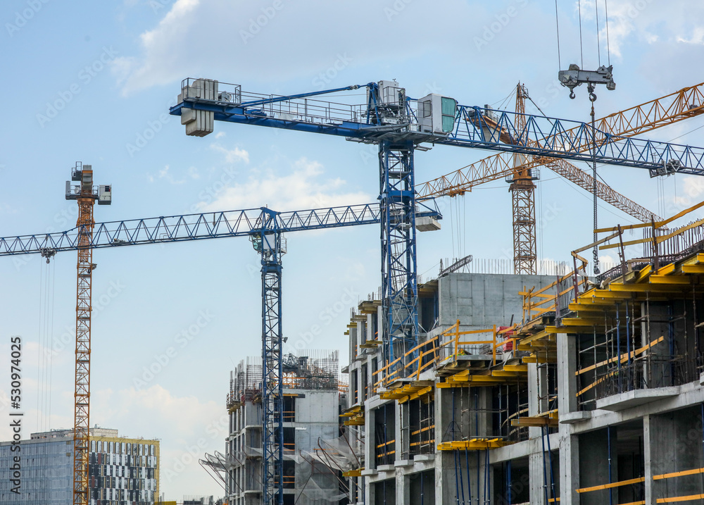 Tower crane at the construction site of a multi-storey building. Tower crane at the construction site of a multi-storey building.